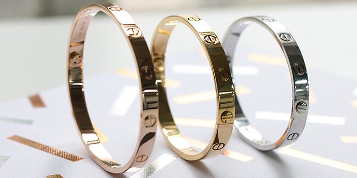 Comparison of Cartier Love bracelets in yellow gold, rose gold, and white gold.